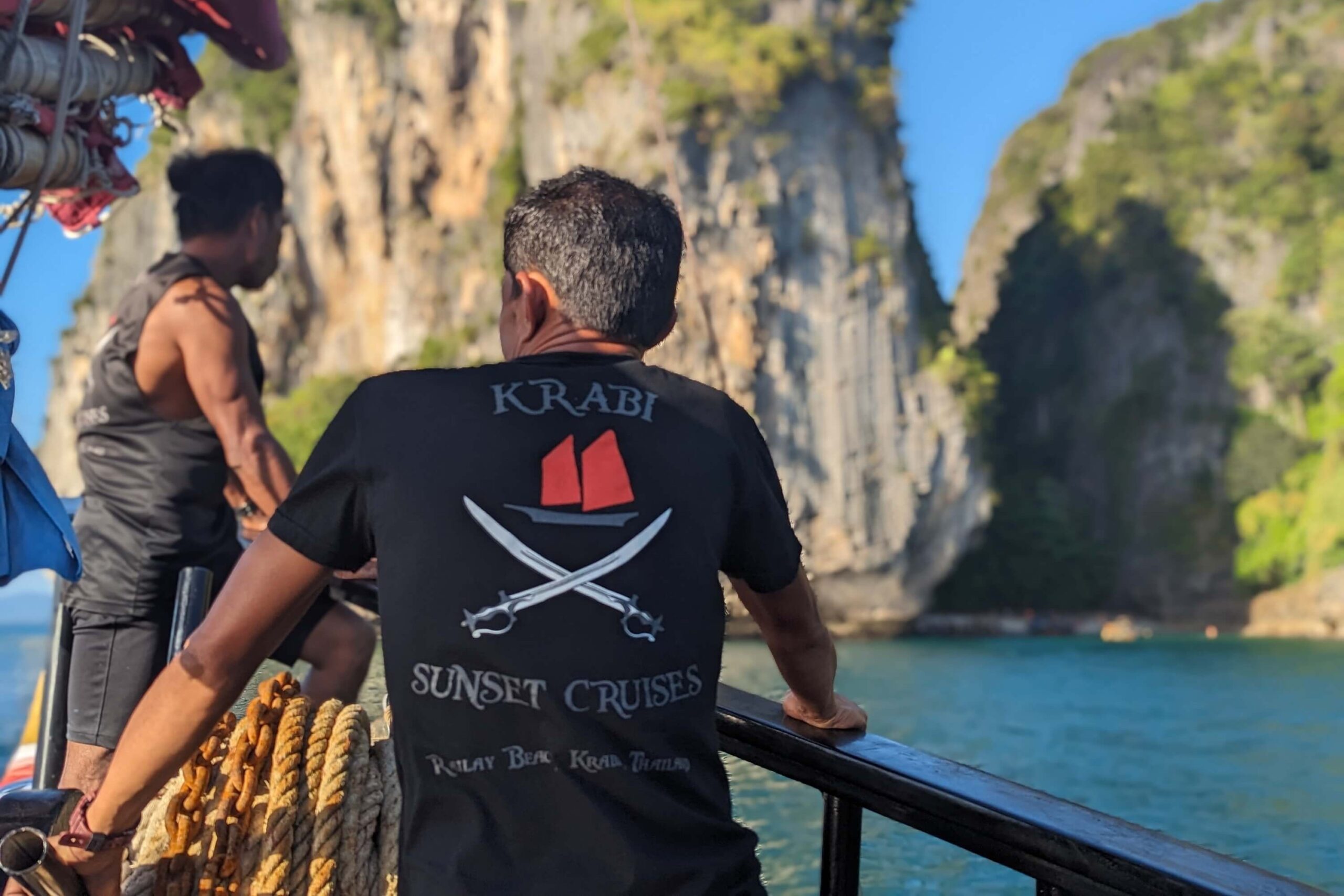krabi sunset cruises crew looking out to the limestone cliffs from the boat