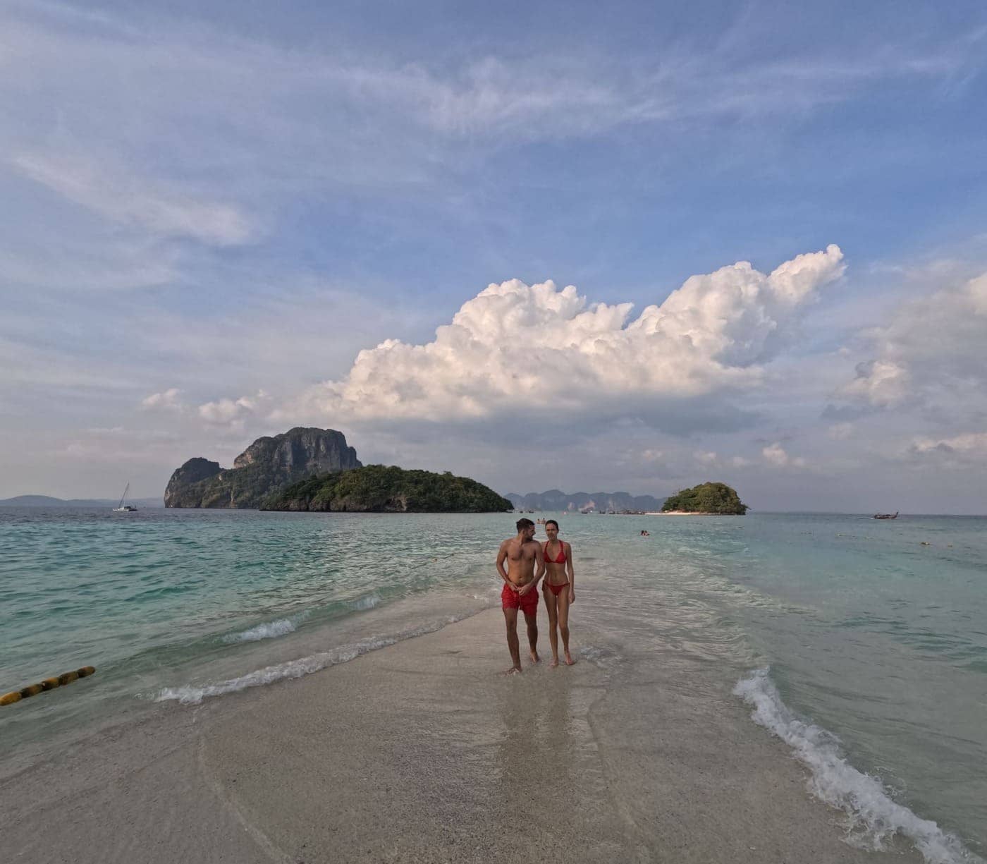 Couple walking along a quiet tropical beach during a private morning boat trip in Krabi.