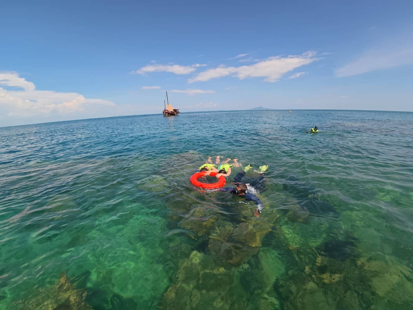 Snorkeling guide accompanying guests over clear tropical water during a private Krabi boat trip.