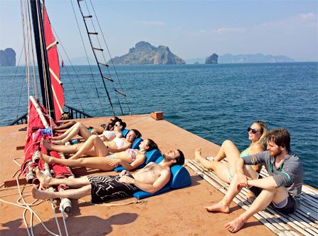 Guests sunbathing onboard The Pla Luang Boat at Krabi Sunset Cruises with sea and islands in the background