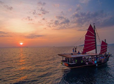 Guests onboard The Pla Luang Boat in Krabi with the sunset in the background